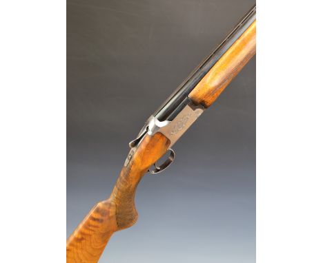 Miroku 12 bore over and under ejector shotgun with engraved locks and underside, chequered semi-pistol grip and forend, singl