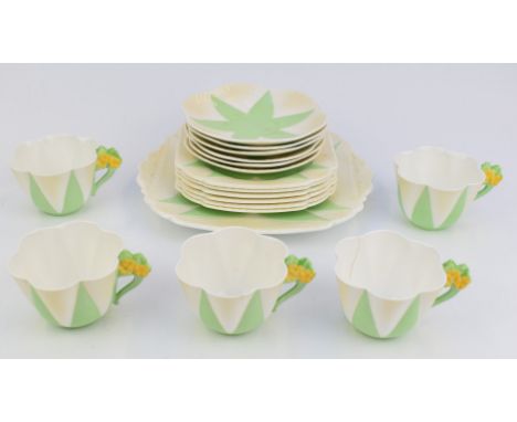 Eighteen pieces of Shelley Art Deco tea ware decorated in the Apple Green Star pattern no 119939, the cups with relief moulde