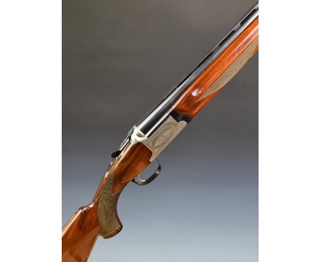 Nikko 612 12 bore over and under ejector shotgun with engraved locks, underside, trigger guard and thumb lever, chequered sem
