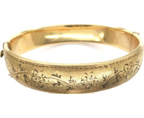 1/5th 9ct gold bangle with engraved floral decoration, 22.8g, D: 68 mm with safety chain. P&amp;P Group 1 (£14+VAT for the fi