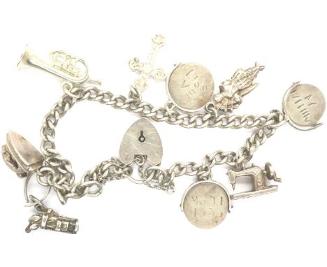 Hallmarked silver charm bracelet with nine charms and hallmarked clasp and safety chain, L: 18 cm, 25g. P&amp;P Group 1 (£14+