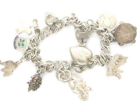 Hallmarked silver charm bracelet with ten charms and hallmarked silver padlock clasp, 30g, L: 20 cm. P&amp;P Group 1 (£14+VAT