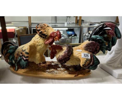A large continental ceramic table centrepiece of fighting cocks