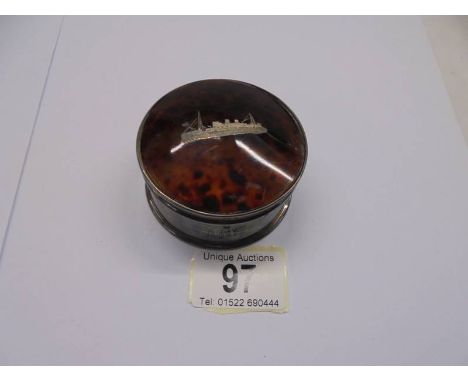 A vintage white metal trinket box featuring a ship.