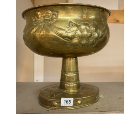 A large brass planter on footed base