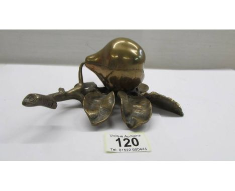 A brass inkstand in the form of a pear on a bed of leaves, (missing glass inkwell).
