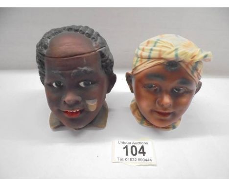 Two ceramic tobacco jars in the form of heads.