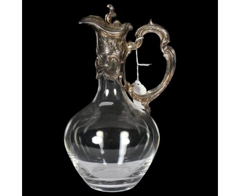 A glass Claret jug with scrolled and embossed silver plated mount and handle, H28cmGood overall condition, just some light su