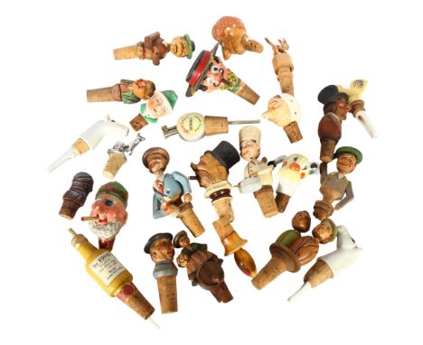 A collection of Vintage novelty bottle stoppers/pourers 