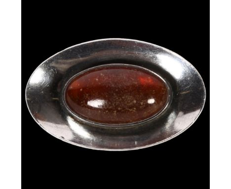 NIEL ERIK FROM - a sterling silver and oval amber set shaped brooch 