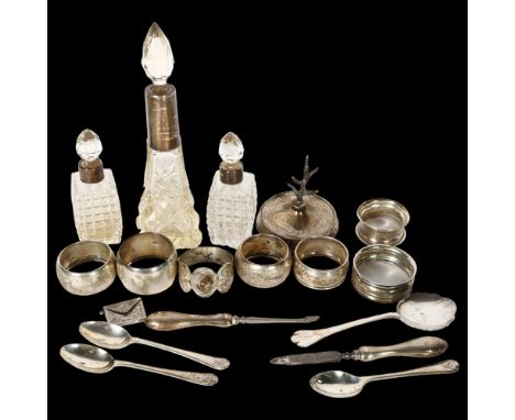 A group of silverware, to include 3 silver-mounted scent bottles, 7 silver napkin rings, silver teaspoons, ring tree, envelop