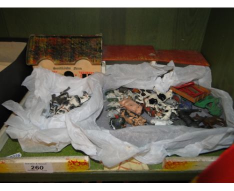 A toy farmyard with Vintage lead animals and vehicles.