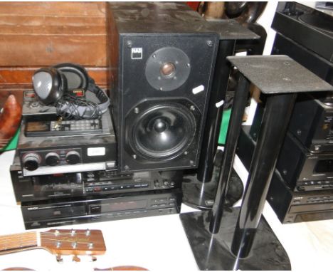 A Denon stereo system with NAD speaker and stands.