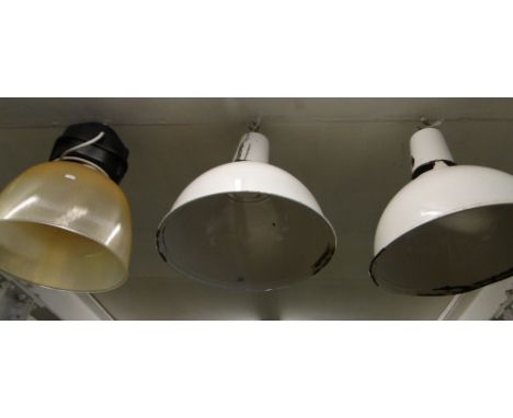 A pair of large enamel industrial ceiling lamps and a glass lamp.