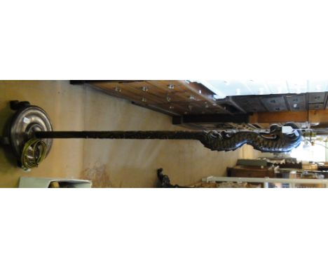 A Chinese rosewood carved dragon design standard lamp.