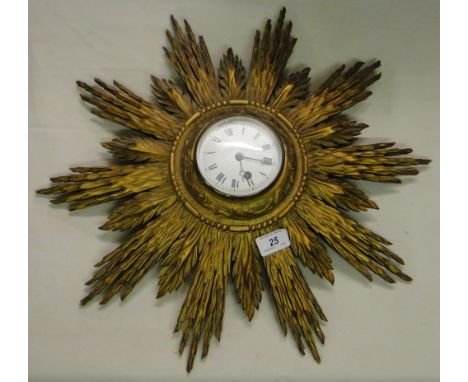 Vintage carved wood sunburst wall clock.