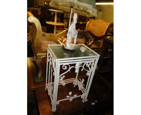 A white painted metal nest of 3 glass top tables and a marble horse table lamp.