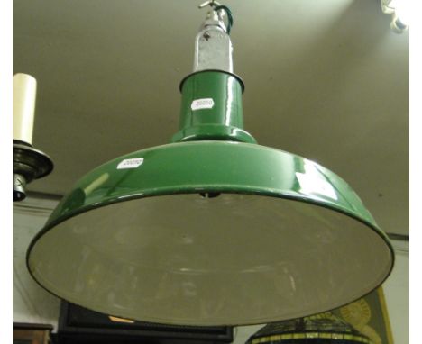 A green enamelled industrial ceiling light.
