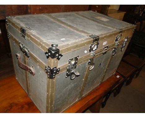 A steel bound aluminium flight trunk with leather carrying handles.