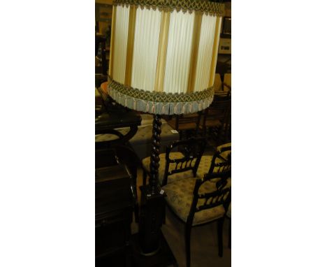 A 1920s oak barleytwist standard lamp and shade.