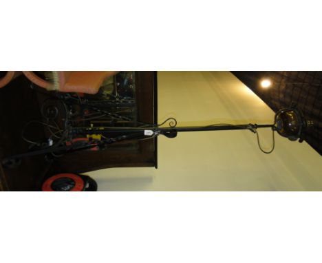 A wrought-iron telescopic standard lamp.