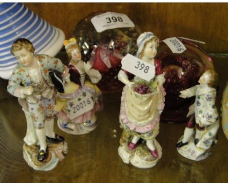 2 Pairs of continental figures and 2 Caithness paperweights.