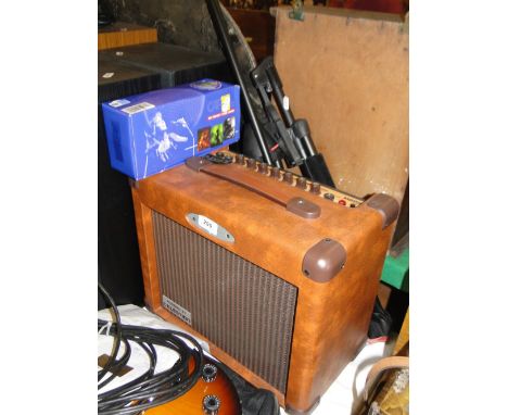 A Kustom amplifier, a microphone and stand, and a guitar stand.