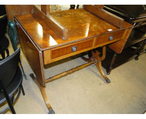 A reproduction mahogany sofa table.