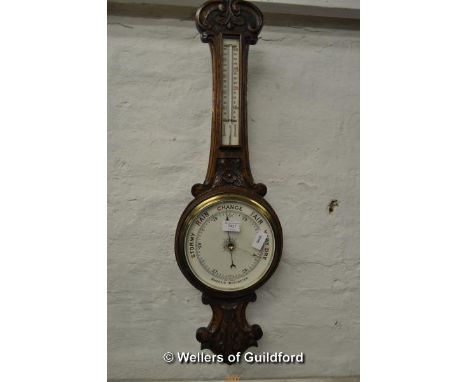 A carved oak banjo aneroid barometer with thermometer.