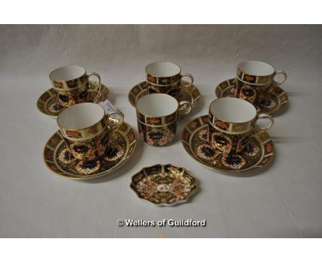 Five Royal Crown Derby imari pattern coffee cans and saucers, an odd saucer and a small pin tray.