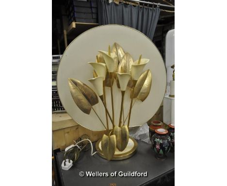 A decorative lamp modelled as a bunch of lillies with cream ceramic flowers and golden metal leaves, 71cm.