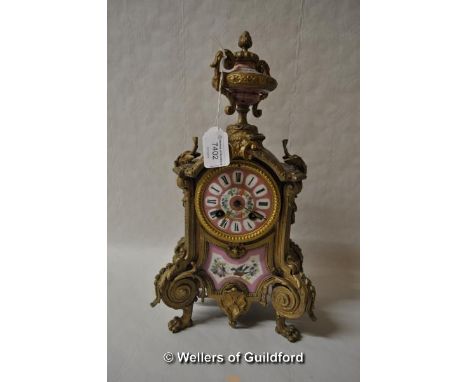 A Victorian gilt metal mantel clock with pink porcelain panels, with urn finial, the pink enamel dial with floral decoration 