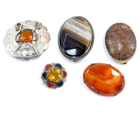 Five Scottish brooches, comprising a Scottish agate banded brooch, with an unmarked white metal mount., a Scottish agate in w