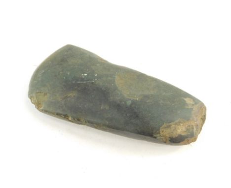A Neolithic period polished axe head, purportedly found near Amesbury in Wiltshire, 11cm wide.