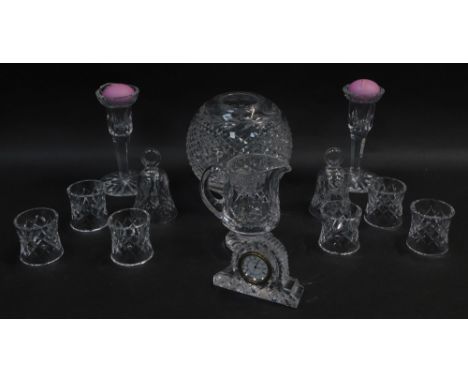 A group of Waterford crystal glassware, including a globular vase, two table bells, a mantel clock, pair of candlesticks, cre