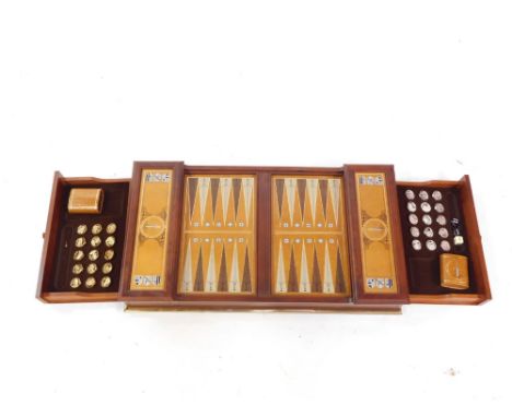 A hardwood backgammon board, of rectangular form with pressed sections and interior drawers set with pieces, dice, etc., 67cm