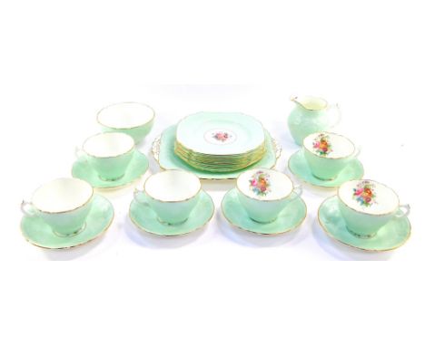 A Coalport porcelain part tea service, decorated with floral sprays against a moulded green ground, comprising bread plate, c