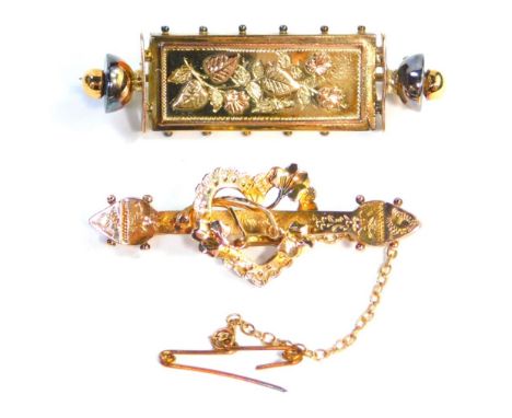 Two bar brooches, comprising a 9ct gold Edwardian bar brooch, with central heart and leaf decoration, 4cm wide, and another 9