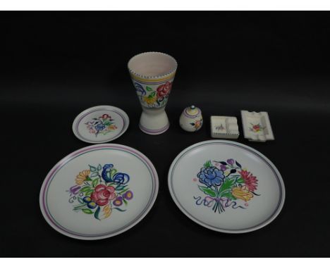 A group of Poole pottery, traditionally painted with flowers, comprising, pair of plates, smaller plate, mustard pot and cove