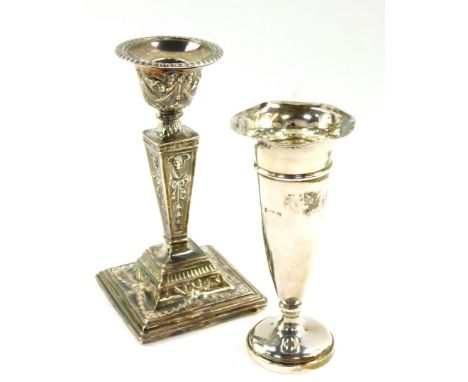 An Edward VII Adam style loaded silver candlestick, embossed with ram's heads, harebells, swags and ribbons, Birmingham 1906,