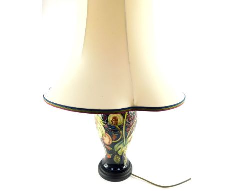 A Moorcroft pottery table lamp decorated in the Queen's Choice pattern, of baluster form, seconds, 46cm high.