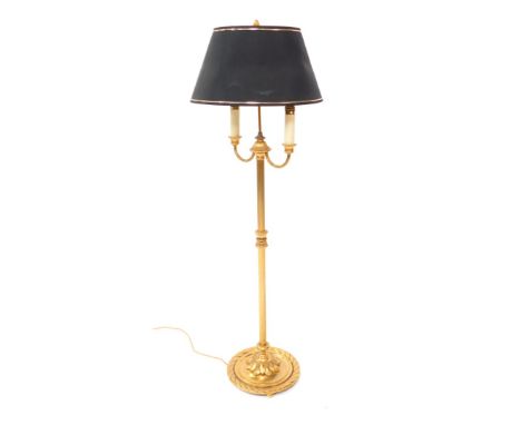 A Georgian style brass twin branch standard lamp, embossed with leaves and a fluted column, raised on a rope twist circular b