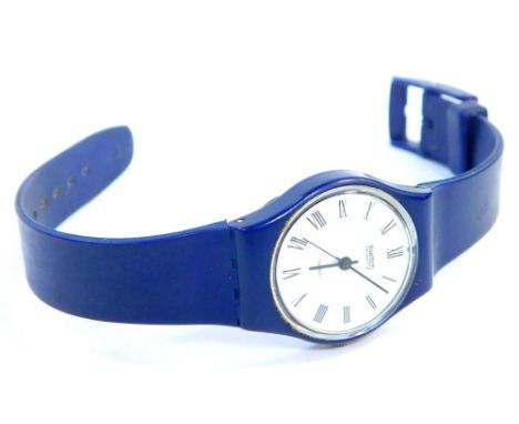 A blue Swatch watch, with white Roman numeral dial, on a royal blue strap, the dial 2cm wide.
