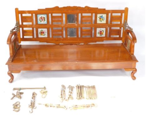 An Indian mid century mango wood swing sofa come daybed, the open and panelled back set with mirrors and painted floral glass