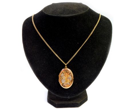 A 9ct gold oval portrait locket, with hammered floral decoration, on a 9ct gold curb link chain, the locket 3.5cm high, the c