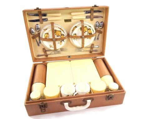 A mid 20thC Brexton picnic hamper, with plastic containers, part pottery service, in a fitted case, 49cm wide.