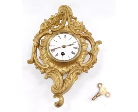 A late 19thC Continental gilt metal cartel wall clock, of rococo form, circular enamel dial bearing Roman numerals, thirty ho