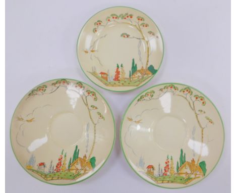 An Art Deco pottery solitaire part tea set, painted in the manner of Clarice Cliff, with a cottage, tall trees and hollyhocks