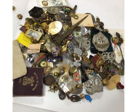 A collection of military badges and buttons together with mixed lots of button hole badges etc., silver shooting medals, a Si