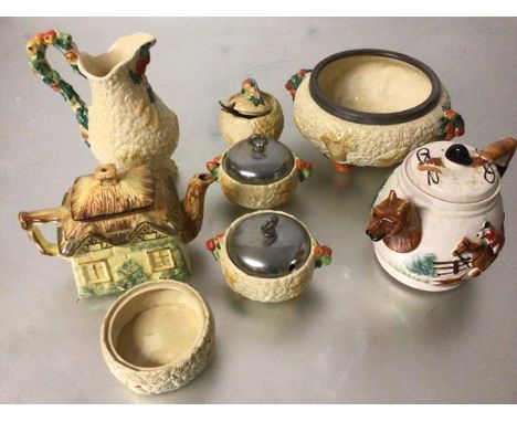 A collection of Clarice Cliff Newport pottery including a fruit bowl with plated rim, two jam dishes with plated tops, a jam 